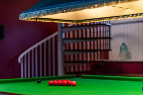 a pool table with red balls on top of it at The Garret in Salisbury