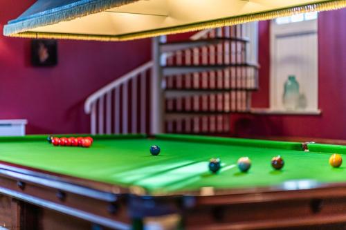 a pool table with balls on top of it at The Garret in Salisbury