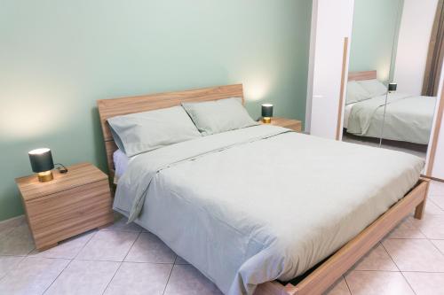 a bedroom with a large bed and a mirror at Lingotto Luxury Apartment in Turin