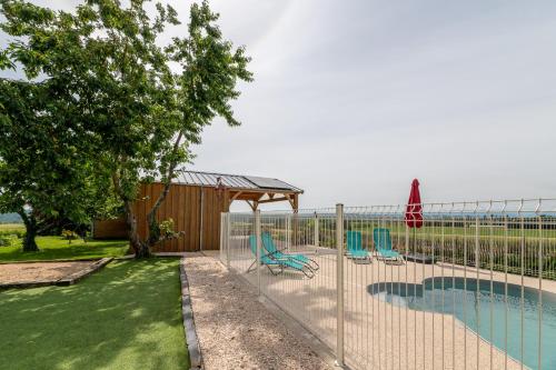 une clôture à côté d'une piscine avec des chaises dans l'établissement Domaine de la Cambre, à Duffort