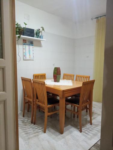 a dining room table with four chairs around it at L'amuri du mare in Trapani