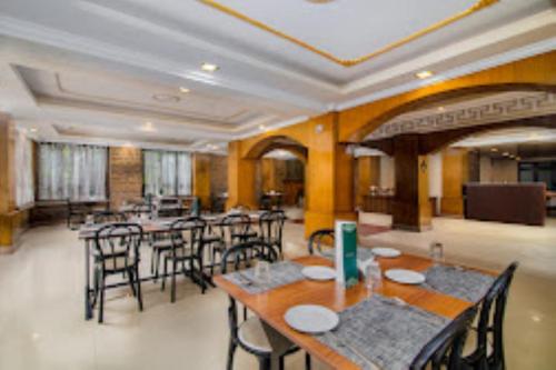 a large dining room with tables and chairs at Hotel Muscatel BhumSang Darjeeling in Darjeeling