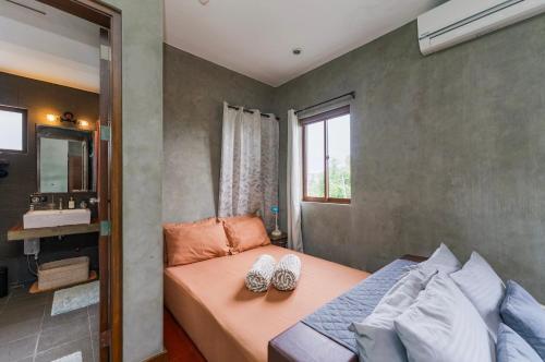a small bedroom with a bed and a window at ISLA VILLA 1 amazing waterfall pool house near beach, bars & restaurants in Mactan