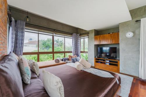 a bedroom with a large bed and a large window at ISLA VILLA 1 amazing waterfall pool house near beach, bars & restaurants in Mactan