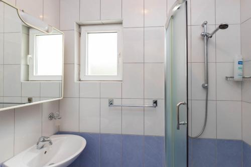 a bathroom with a sink and a shower at Apartments Cipetic in Kaštela