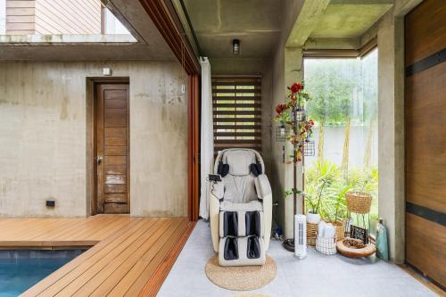 a stroller sitting on a porch next to a swimming pool at ISLA VILLA 1 amazing waterfall pool house near beach, bars & restaurants in Mactan