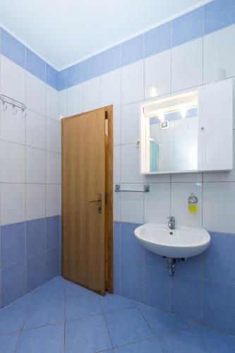 a bathroom with a sink and a mirror at Apartments Cipetic in Kaštela