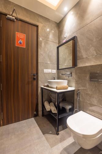 a bathroom with a sink and a toilet at Kohsa7 in Gurgaon