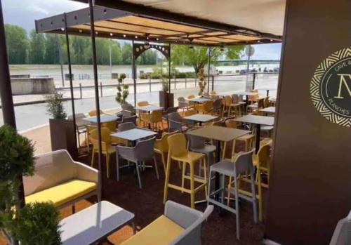 a restaurant with tables and chairs on a patio at détente centre historique de MÂCON avec spa et ciné in Mâcon