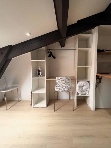 ein Wohnzimmer mit einem Stuhl und Regalen in der Unterkunft Cozy studio near Casino Monte-Carlo in Beausoleil
