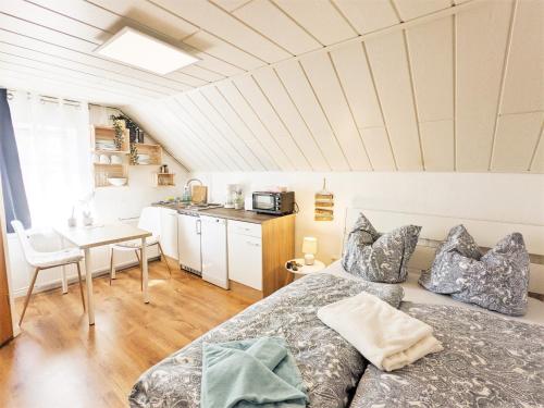 ein Schlafzimmer mit einem Bett und einem Tisch sowie eine Küche in der Unterkunft Urlaubsmagie - Wohlfühloase mit Pool - H5 in Sebnitz