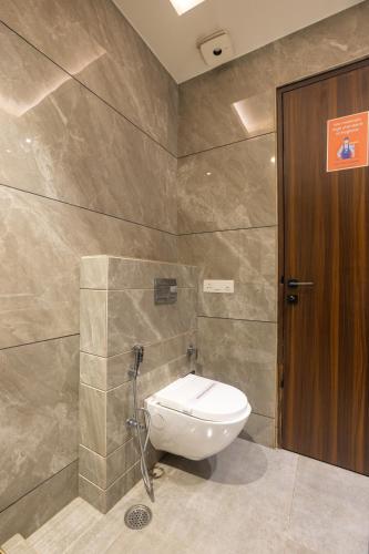 a bathroom with a toilet and a shower stall at Kohsa7 in Gurgaon