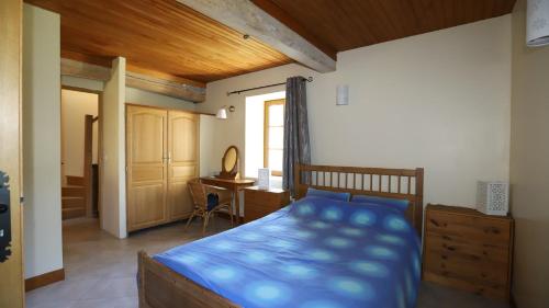 a bedroom with a bed and a desk in it at Gite complex near Mirepoix in the Pyrenees in Limbrassac