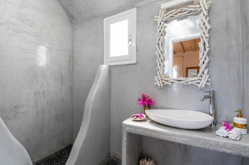 a bathroom with a white sink and a mirror at Margarita House in Mýkonos City