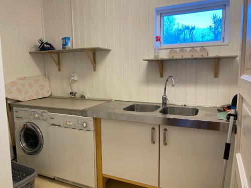 a kitchen with a sink and a washing machine at Per-Sims in Ljusdal