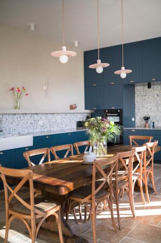 a dining room with a wooden table and chairs at Maison La Grande Ourse in Beaucens