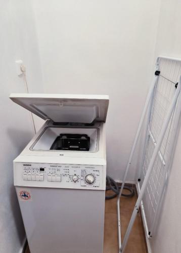 a white refrigerator with a microwave on top of it at Apartmány Pražská in Ústí nad Labem