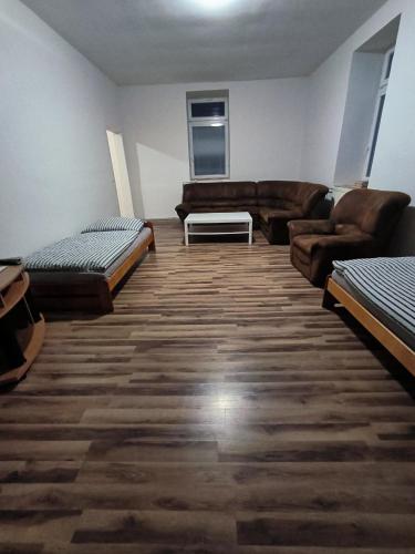 a living room with two beds and a couch at Apartmány Pražská in Ústí nad Labem