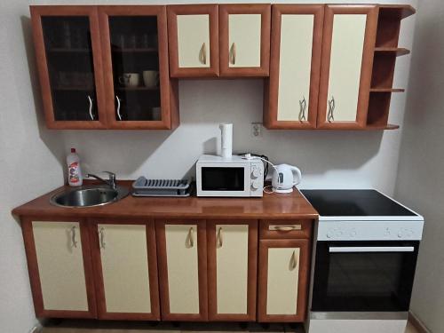 a small kitchen with a microwave and a sink at Apartmány Pražská in Ústí nad Labem