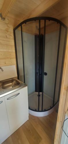 a small room with a glass door in a kitchen at Chez Sylvie et Stéphane in Le Mans