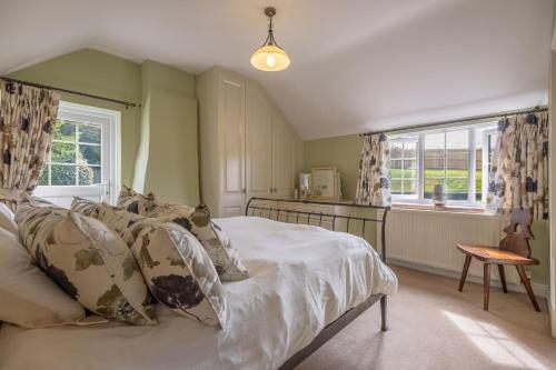 a bedroom with a bed and a window at Cheney Hollow in Heacham