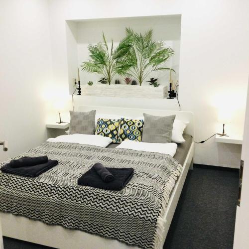 a bedroom with a bed with black towels on it at Baky House in Balatonlelle