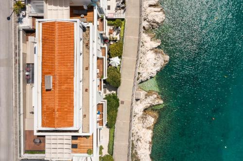 an aerial view of a building and the water at Boutique Hotel Adoral in Rabac