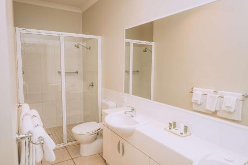 a bathroom with a sink and a toilet and a shower at Best Western Chaffey Motor Inn in Mildura