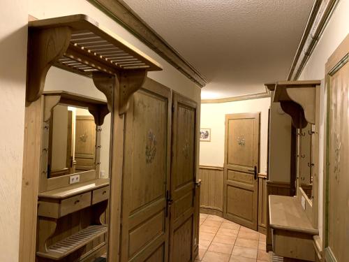 a bathroom with wooden cabinets and a sink in a room at les 7 laux immobilier chalet B in Prapoutel