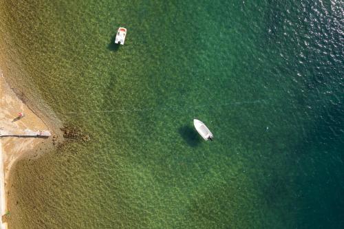 an overhead view of boats in the grass near the water at Zoe Seaside in Loutra Edipsou