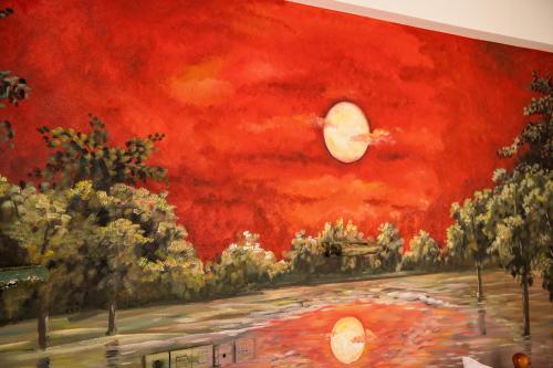 a painting of a red sky with the moon at Zoe Seaside in Loutra Edipsou