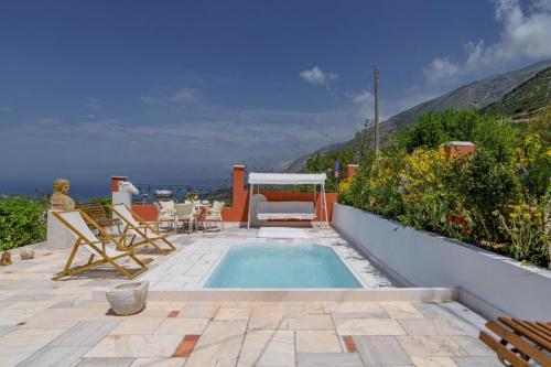 a small swimming pool with chairs and a table at Art Gallery Villa Kefalonia Sea View and Breakfast in Kardhakáta