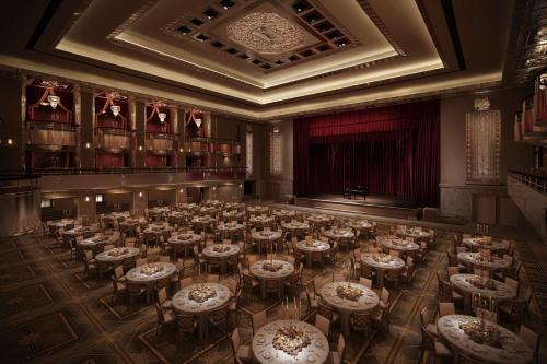 a large room with tables and chairs in it at Waldorf Astoria New York in New York