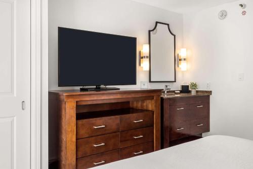 a television on top of a dresser in a bedroom at Embassy Suites by Hilton Los Angeles International Airport South in El Segundo