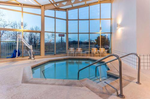 a swimming pool in a building with a large window at La Quinta by Wyndham Chicago Gurnee in Gurnee