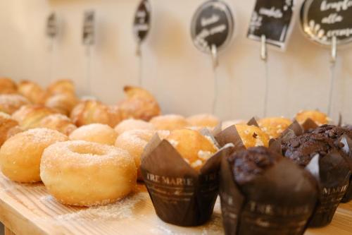 a table topped with lots of donuts on top at Hotel Motel 2000 in Trezzano sul Naviglio