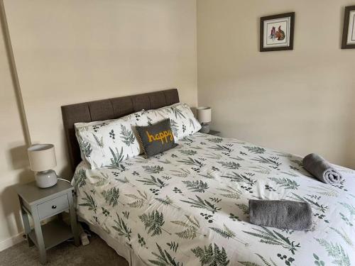 a bedroom with a bed with a green and white comforter at Historic Unique Castle Apartment in Central Perth in Perth