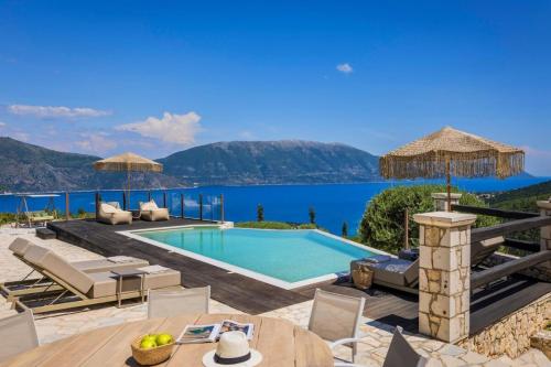 a villa with a swimming pool and a view of the water at Villa Bolios Sea view Private Pool in Matsoukáta