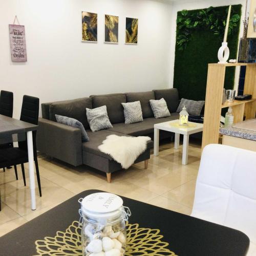 a living room with a couch and a table at Baky House in Balatonlelle