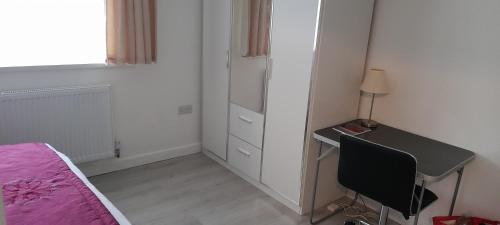 a bedroom with a desk and a bed and a table and chair at Appendix 254 in Oldbury