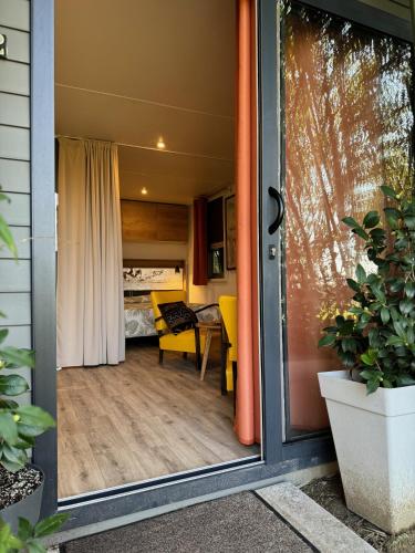 a sliding glass door leading to a room with a bedroom at Palazzo delle Biscie - Old Tower & Village in Molinella