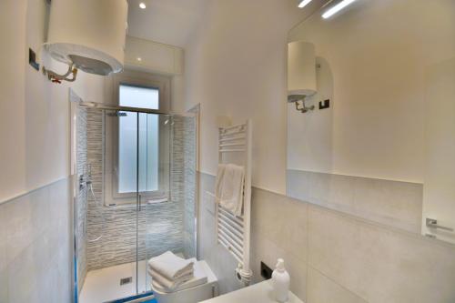 a bathroom with a shower and a toilet and a sink at Piazza Della Vittoria Apartment in Genoa