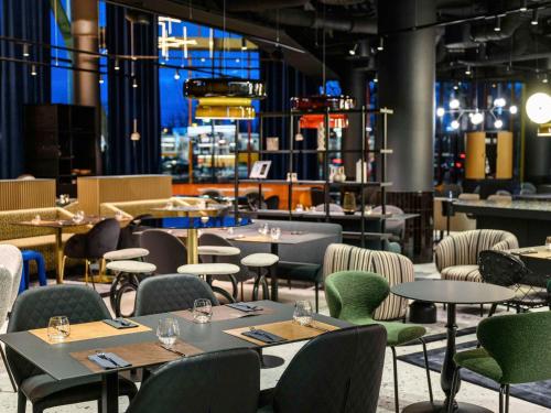 a dining room with tables and chairs and tablesktop at ibis Budapest Stadium in Budapest