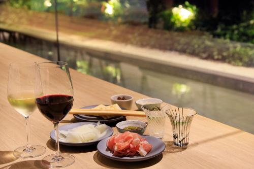 a table with glasses of wine and food on it at Richmond Hotel Premier Kyoto Shijo in Kyoto