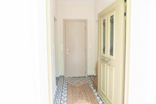 a hallway with a door and a rug on the floor at Kosnian City Suites in Kos