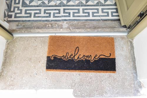 a welcome mat on the floor in front of a door at Kosnian City Suites in Kos
