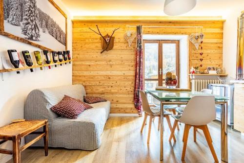 a living room with a couch and a glass table at Il Baitino Innamorato in Pragelato