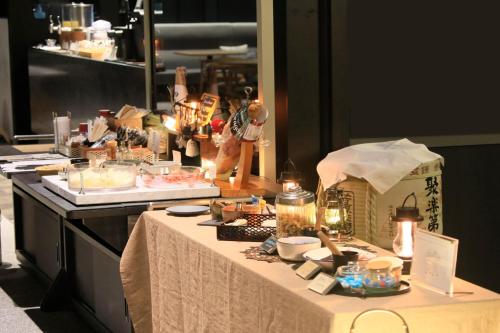 a table with food and other items on it at Richmond Hotel Premier Kyoto Shijo in Kyoto