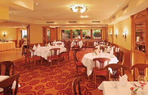 a restaurant with tables and chairs in a room at Landhotel Goldener Acker in Morsbach