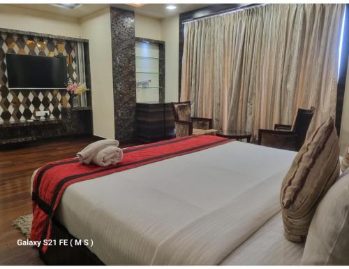 מיטה או מיטות בחדר ב-Hotel Silver Arcade Premier, Malda, WB